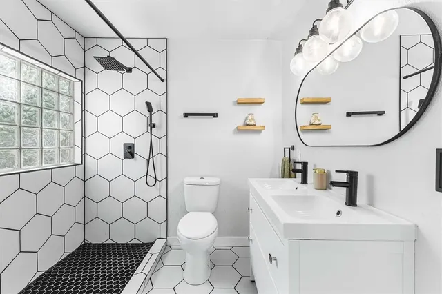 a bathroom with a sink a toilet and a mirror