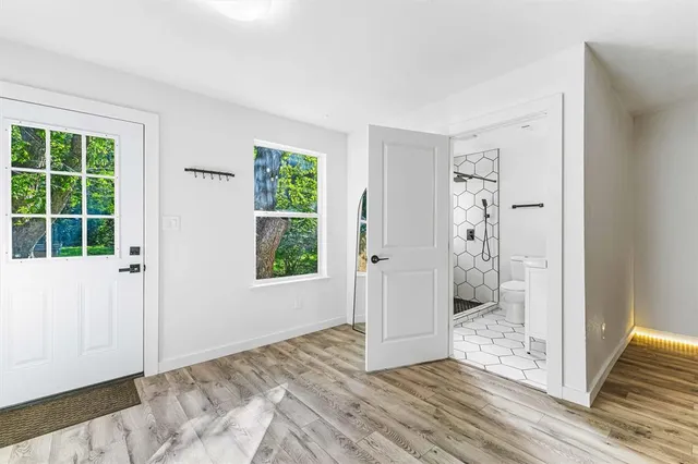 a view of empty room with window and front door