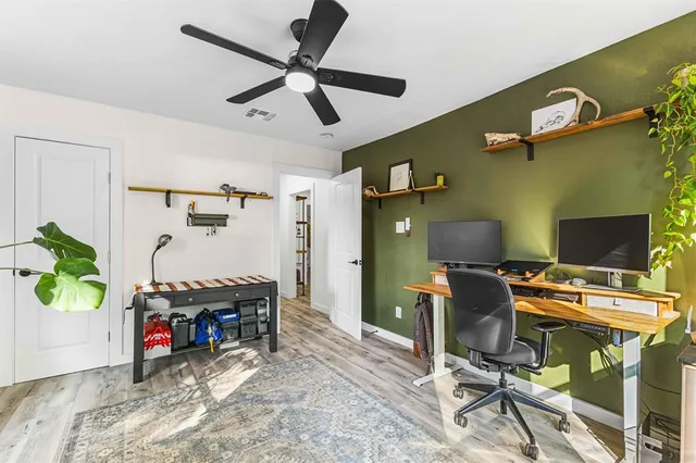 a view of a workspace with furniture and a window