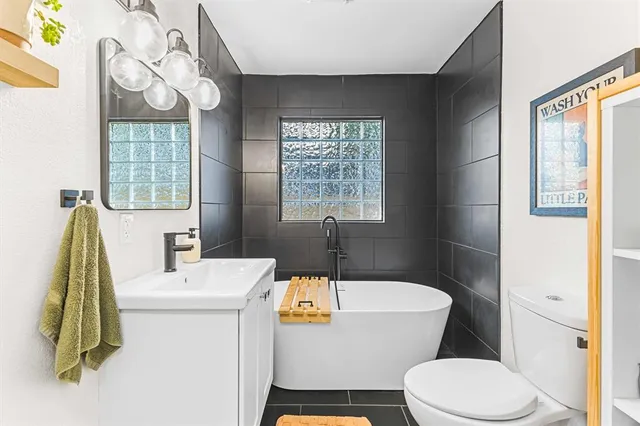 a bathroom with a sink a toilet and a mirror