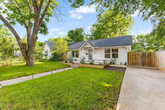 a front view of a house with yard patio and green space