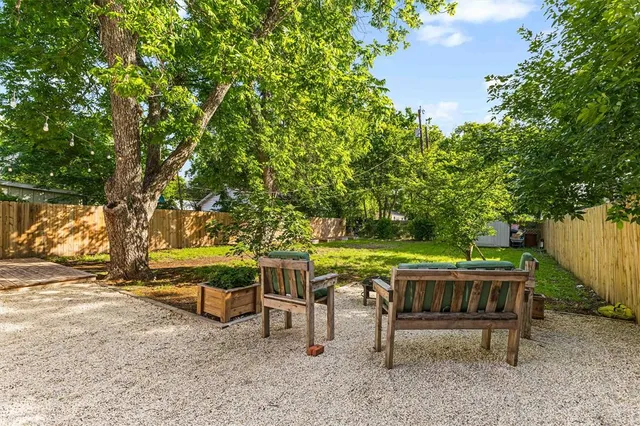 a backyard of a house with table and chairs