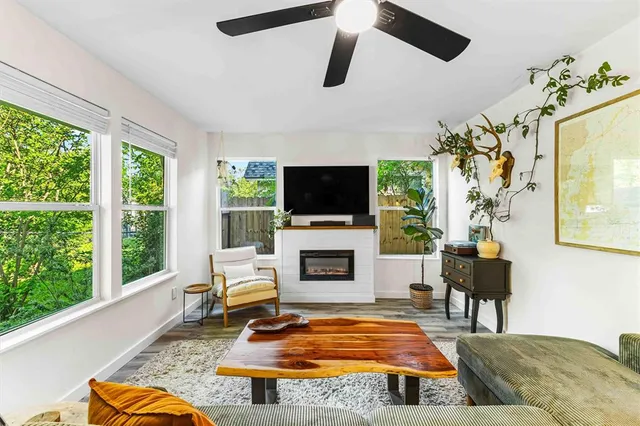 a living room with furniture fireplace and flat screen tv