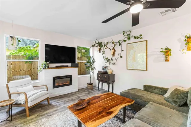 a bedroom with furniture fireplace and a flat screen tv