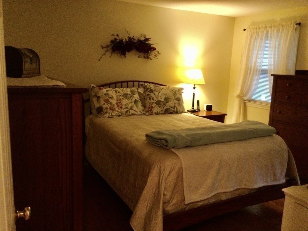 30 Meadow Road Ware, MA 01082 - Photo 14 of 26 a bedroom with a bed and a painting on the wall