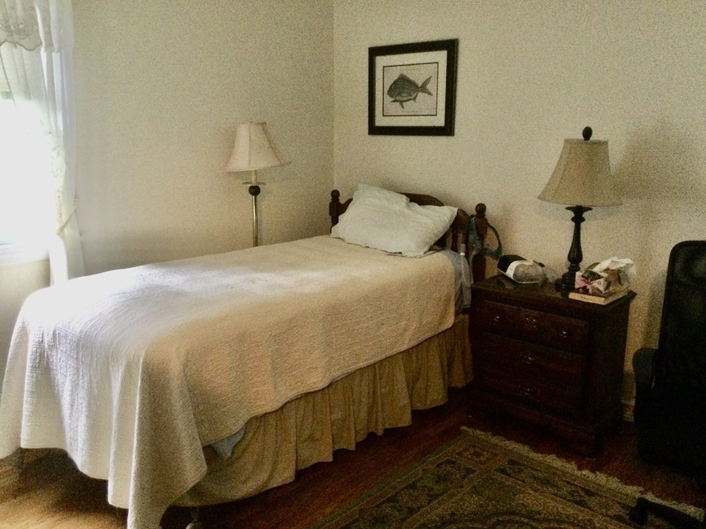 30 Meadow Road Ware, MA 01082 - Photo 15 of 26 a bedroom with a bed and wooden floor