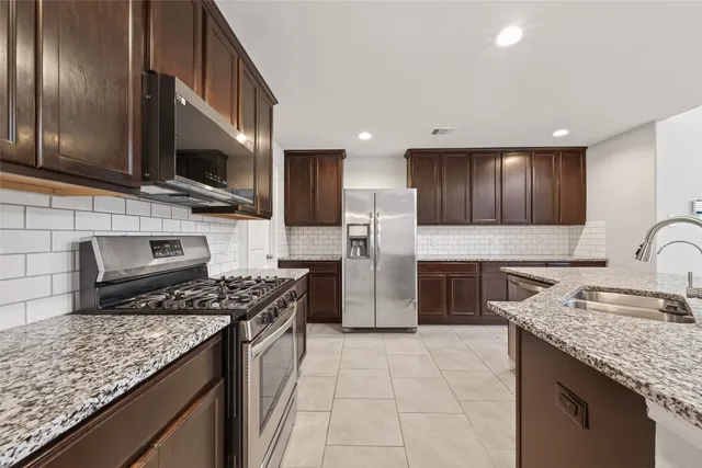 a kitchen with a stove and a refrigerator