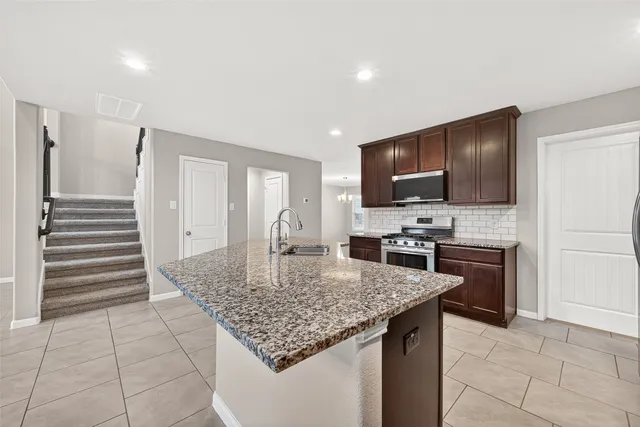 a kitchen with stainless steel appliances granite countertop a sink counter space cabinets and a sink