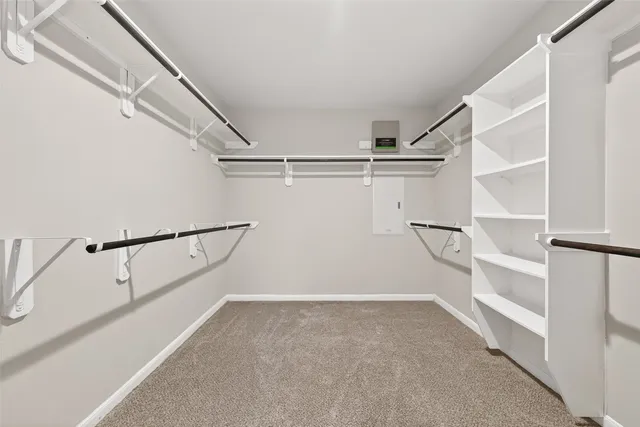 a view of an empty room with a ceiling fan