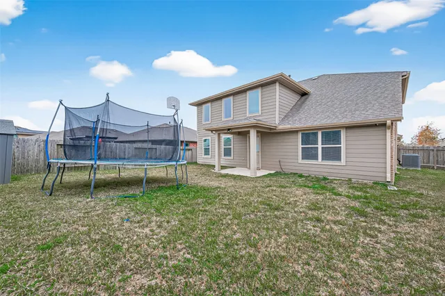 a view of a house with backyard and porch