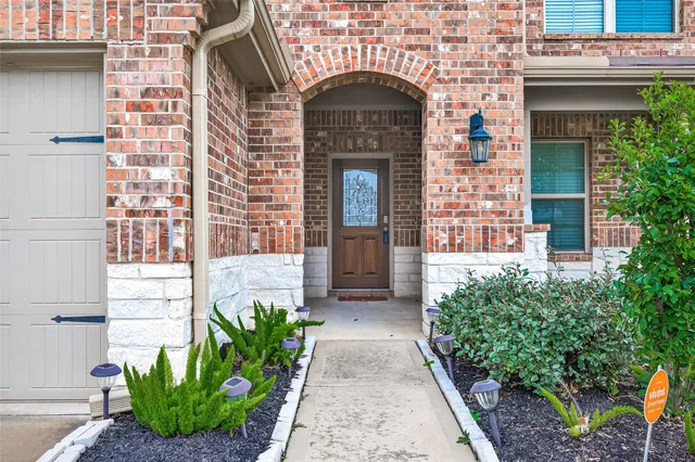 a front view of a house with potted plants