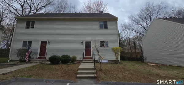 a view of a house with a yard and garage