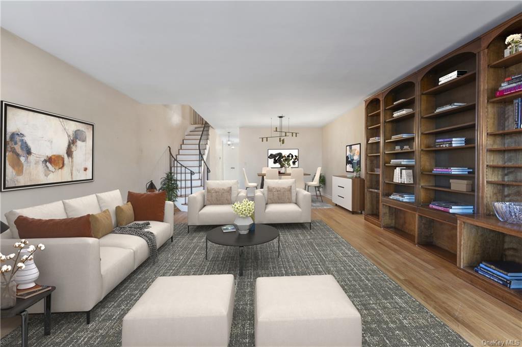 a living room with furniture and a book shelf