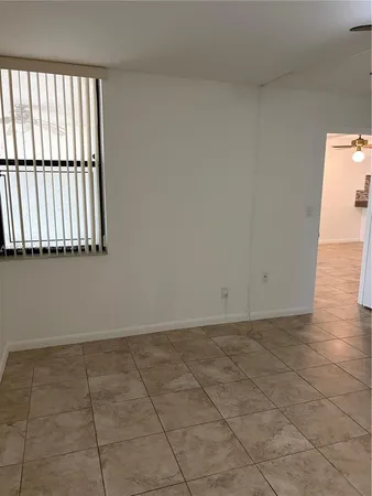 a view of a room with wooden floor and a window