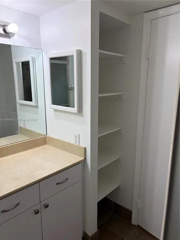 a bathroom with a sink and vanity