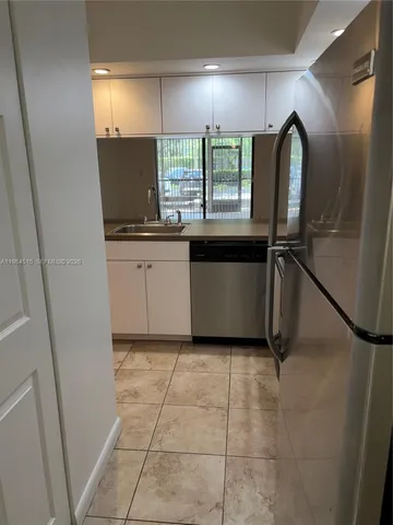 a view of a kitchen with a sink and a window