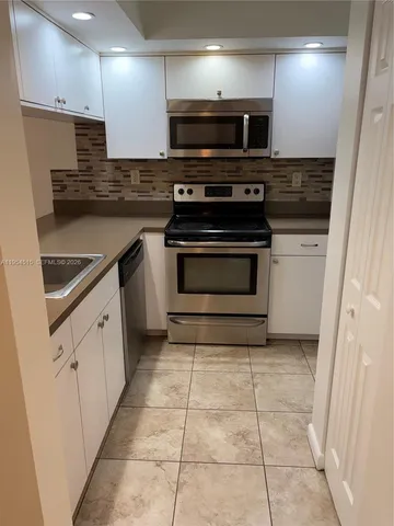 a kitchen with a stove and a microwave