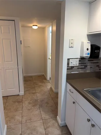a view of a kitchen with microwave and cabinets
