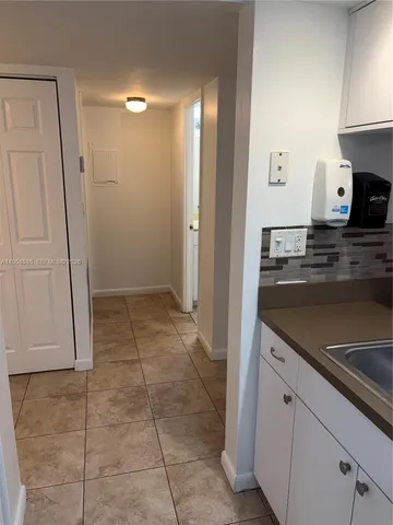 a view of a kitchen with microwave and cabinets