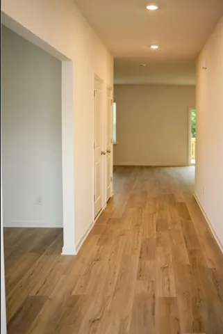 a view of hallway with wooden floor