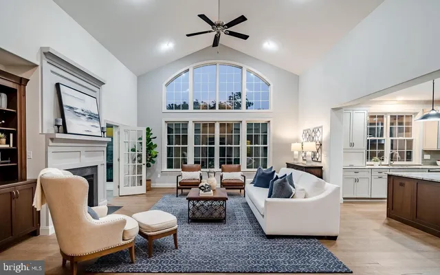 a living room with fireplace furniture and a large window