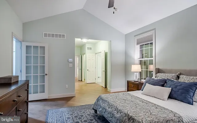 a bedroom with a bed and a window