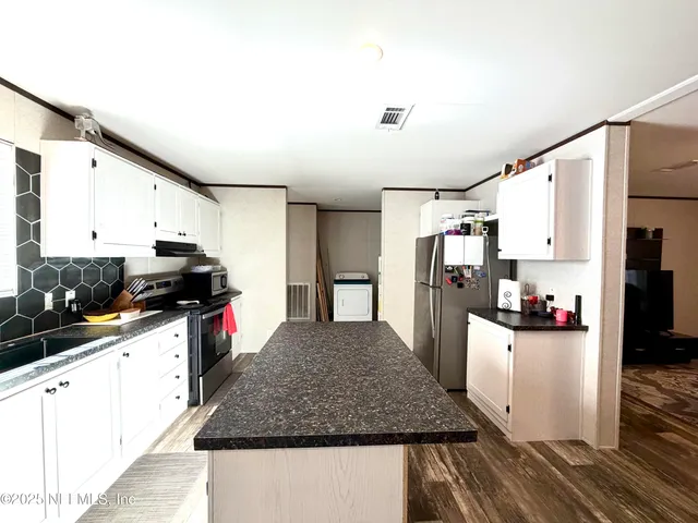 a kitchen with refrigerator and stove