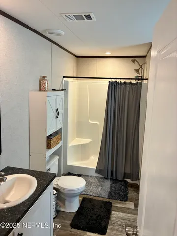 a bathroom with a toilet a sink and a shower