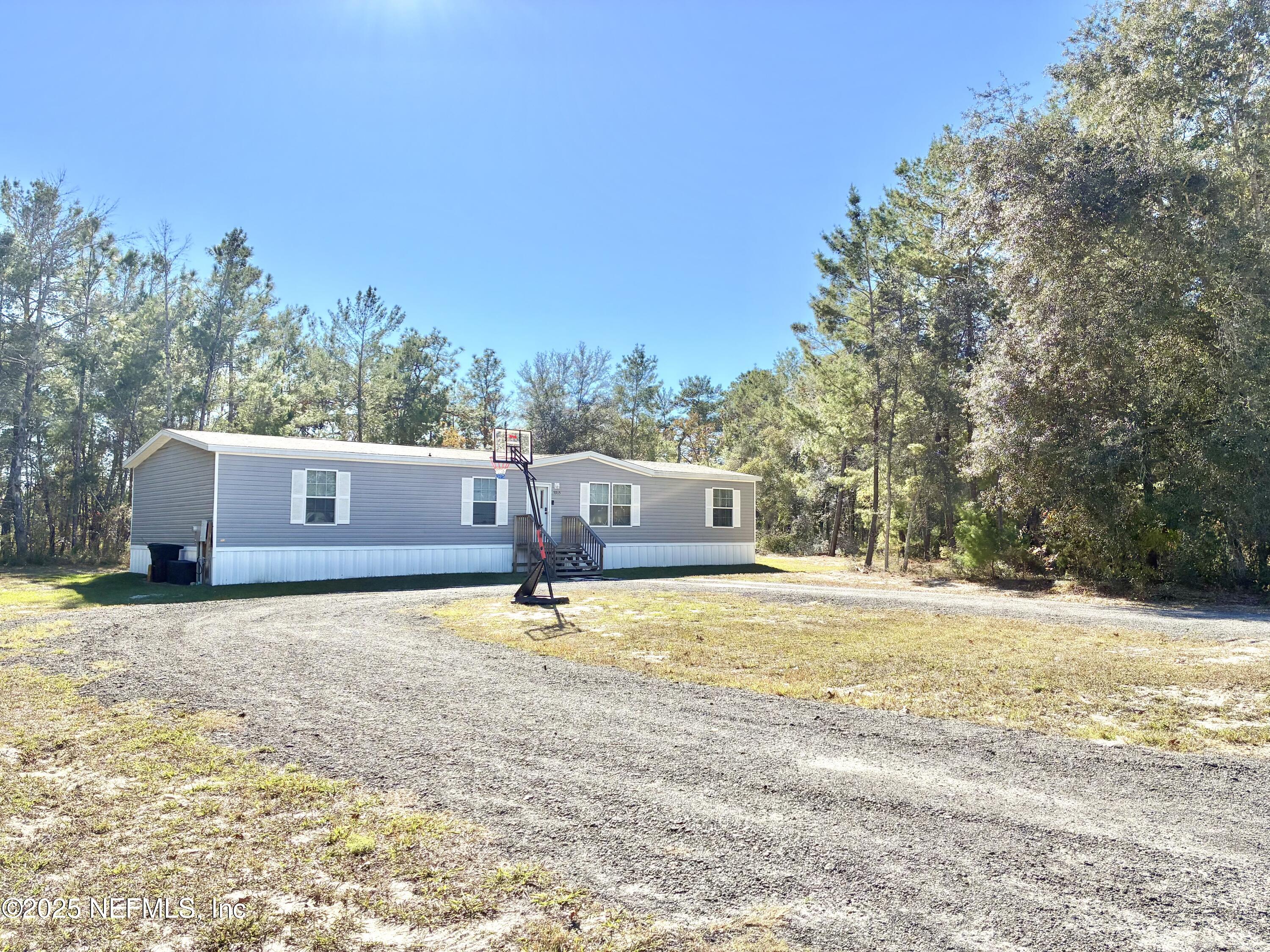 5915 Oak Leaf Road Keystone Heights, FL 32656 - Photo 2 of 44 a view of a house with a yard