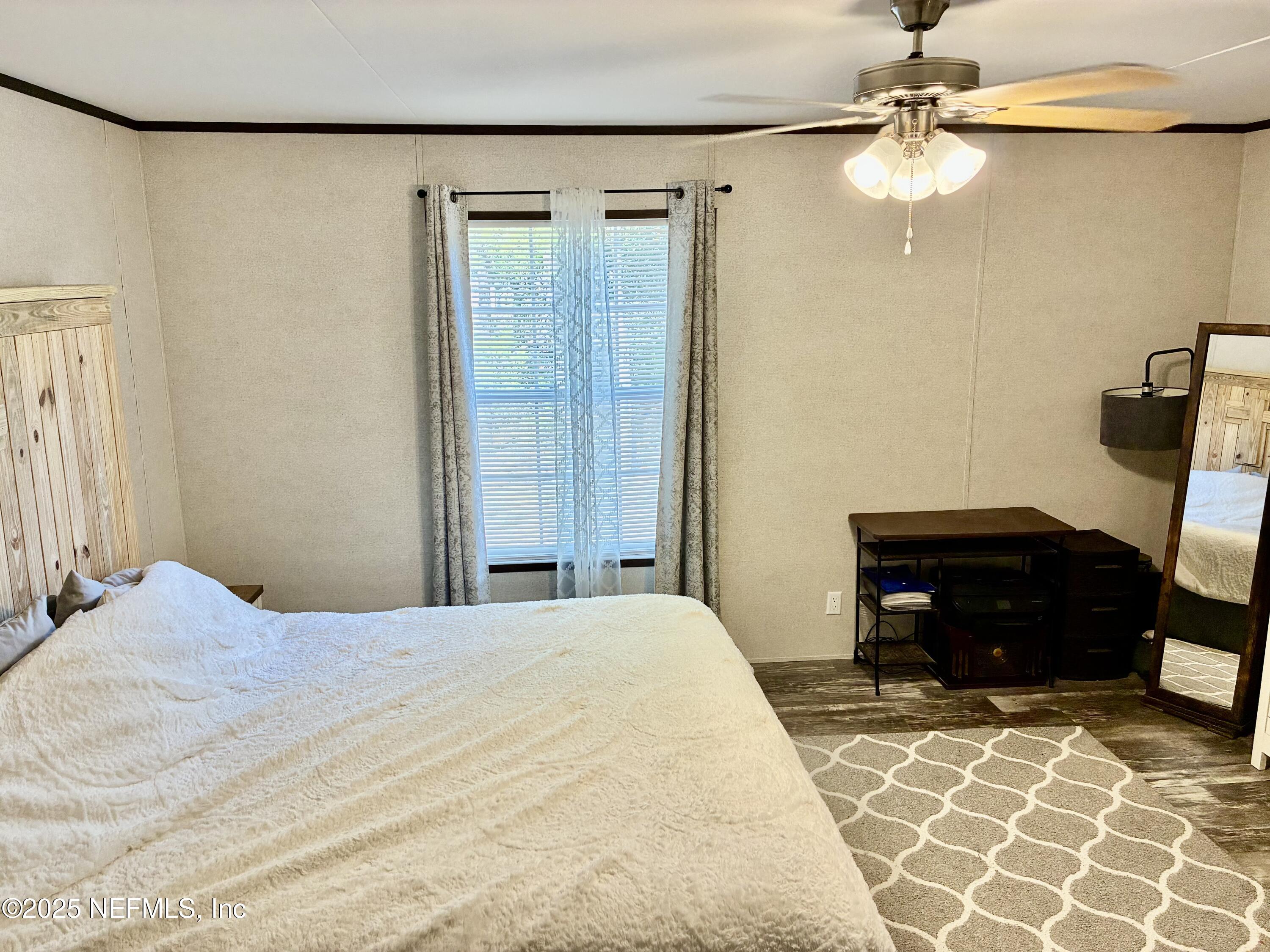 5915 Oak Leaf Road Keystone Heights, FL 32656 - Photo 25 of 44 a bedroom with a bed and a dresser