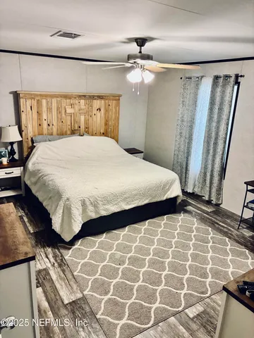 a bedroom with a bed and a mirror