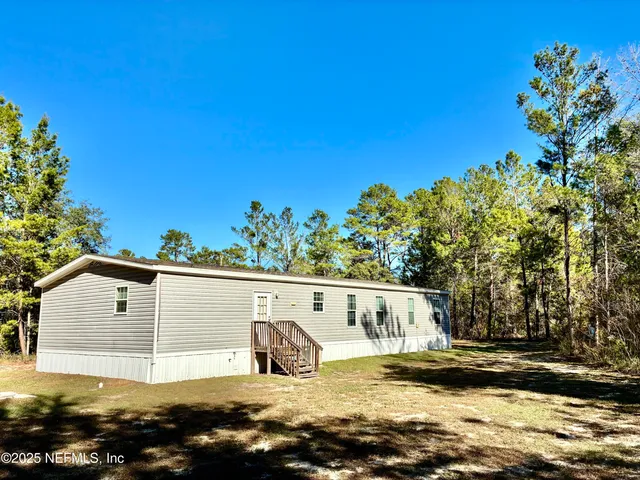 a view of a back yard of the house