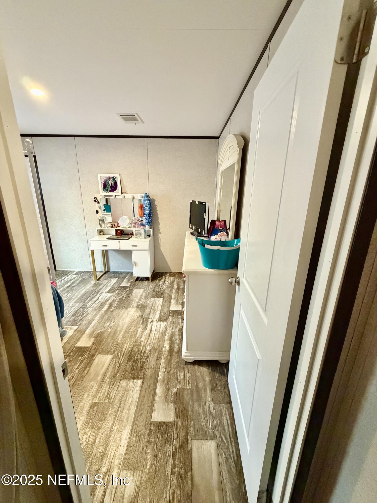 5915 Oak Leaf Road Keystone Heights, FL 32656 - Photo 32 of 44 a view of a living room with a baby crib and a couch