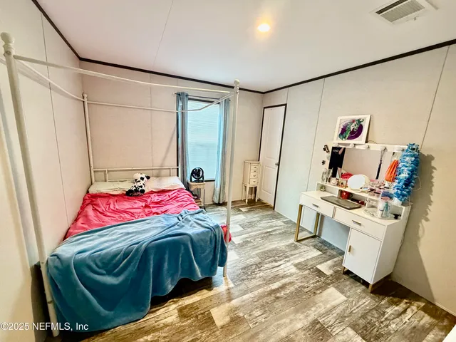 a bedroom with a bed and a couch