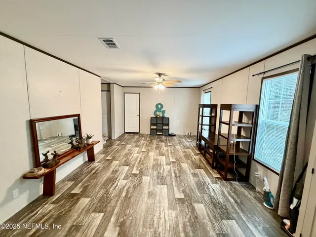 a room with wooden floor and furniture