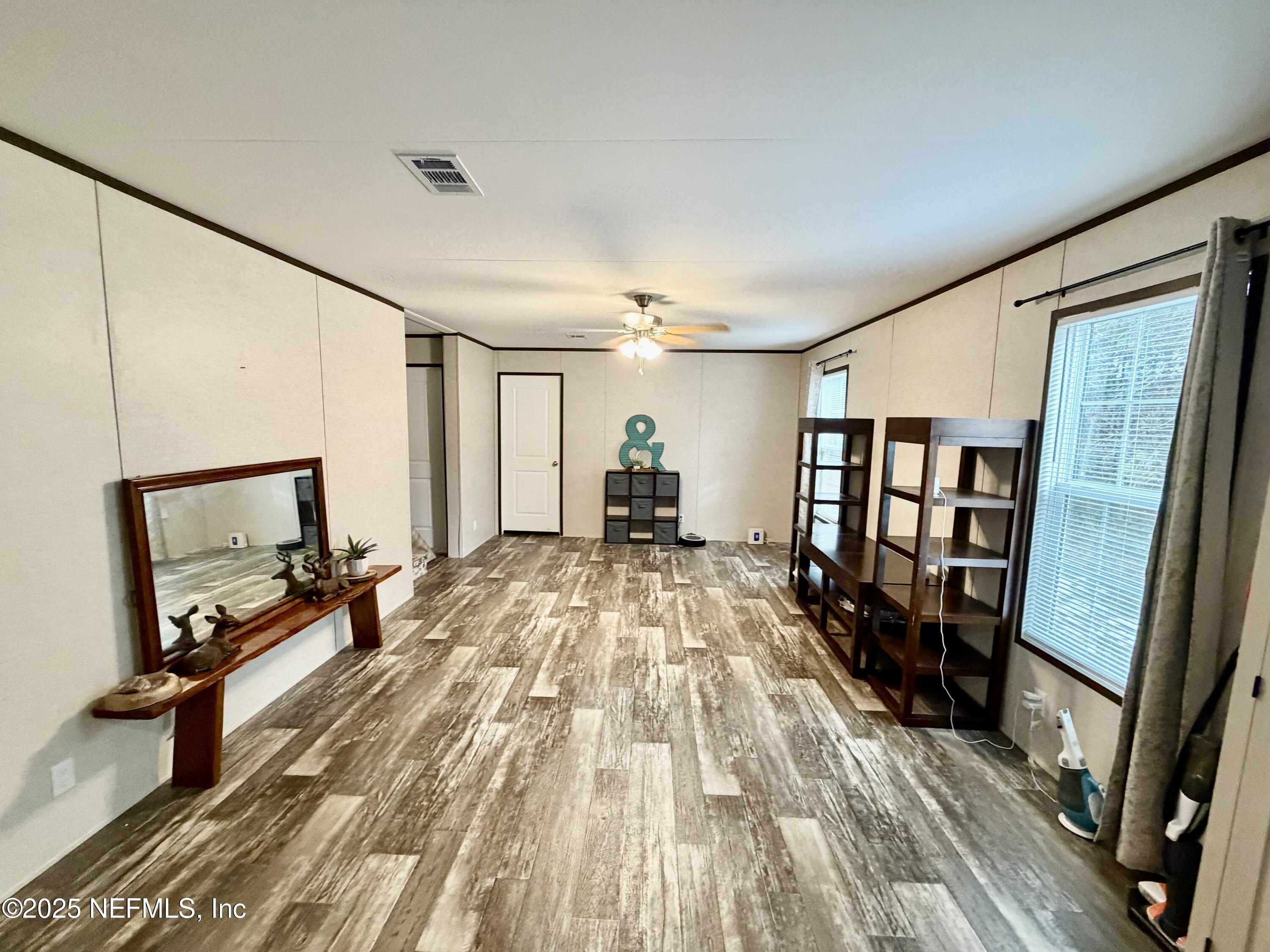 5915 Oak Leaf Road Keystone Heights, FL 32656 - Photo 36 of 44 a room with wooden floor and furniture