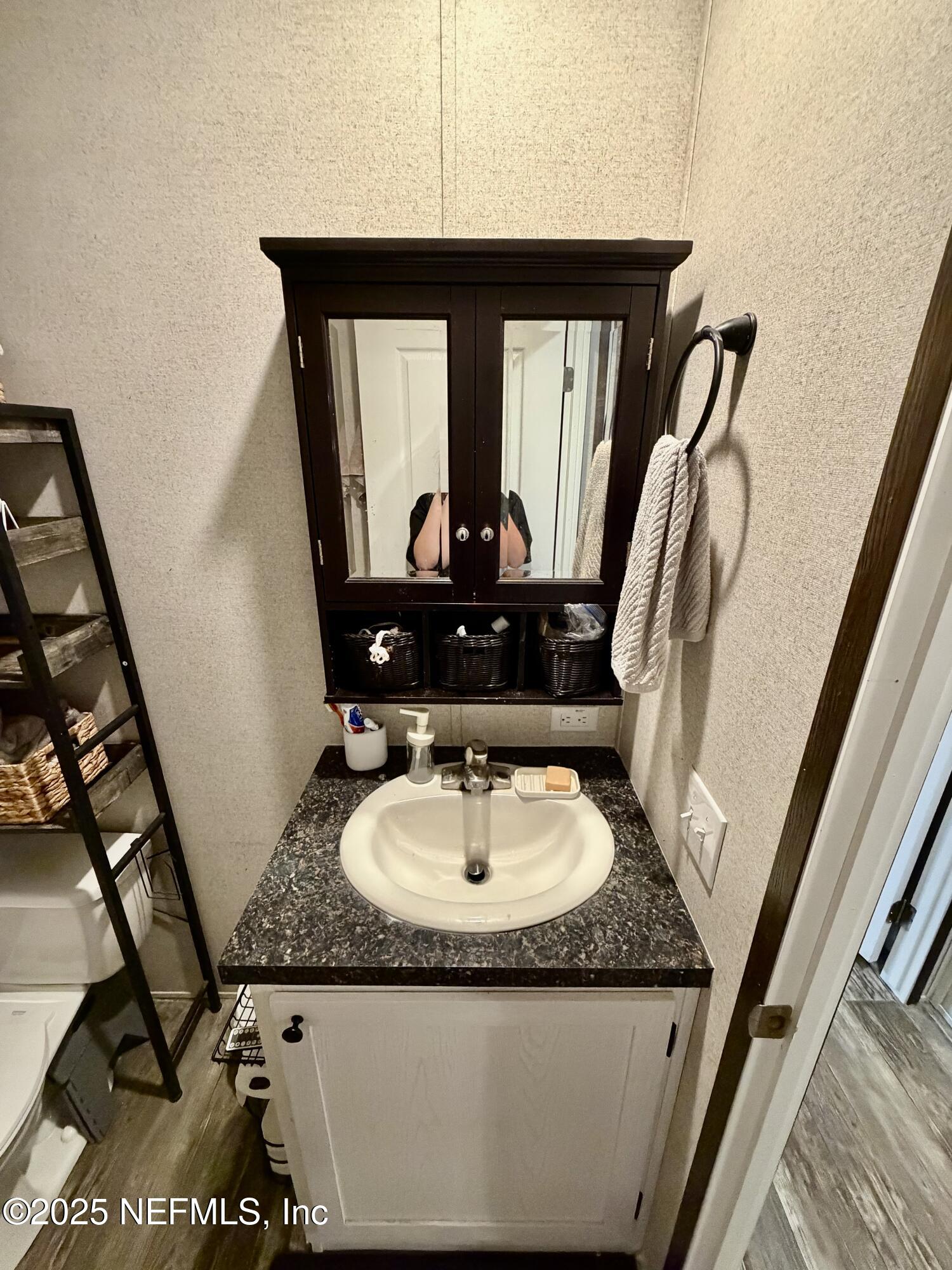 5915 Oak Leaf Road Keystone Heights, FL 32656 - Photo 40 of 44 a bathroom with a granite countertop sink a mirror and vanity