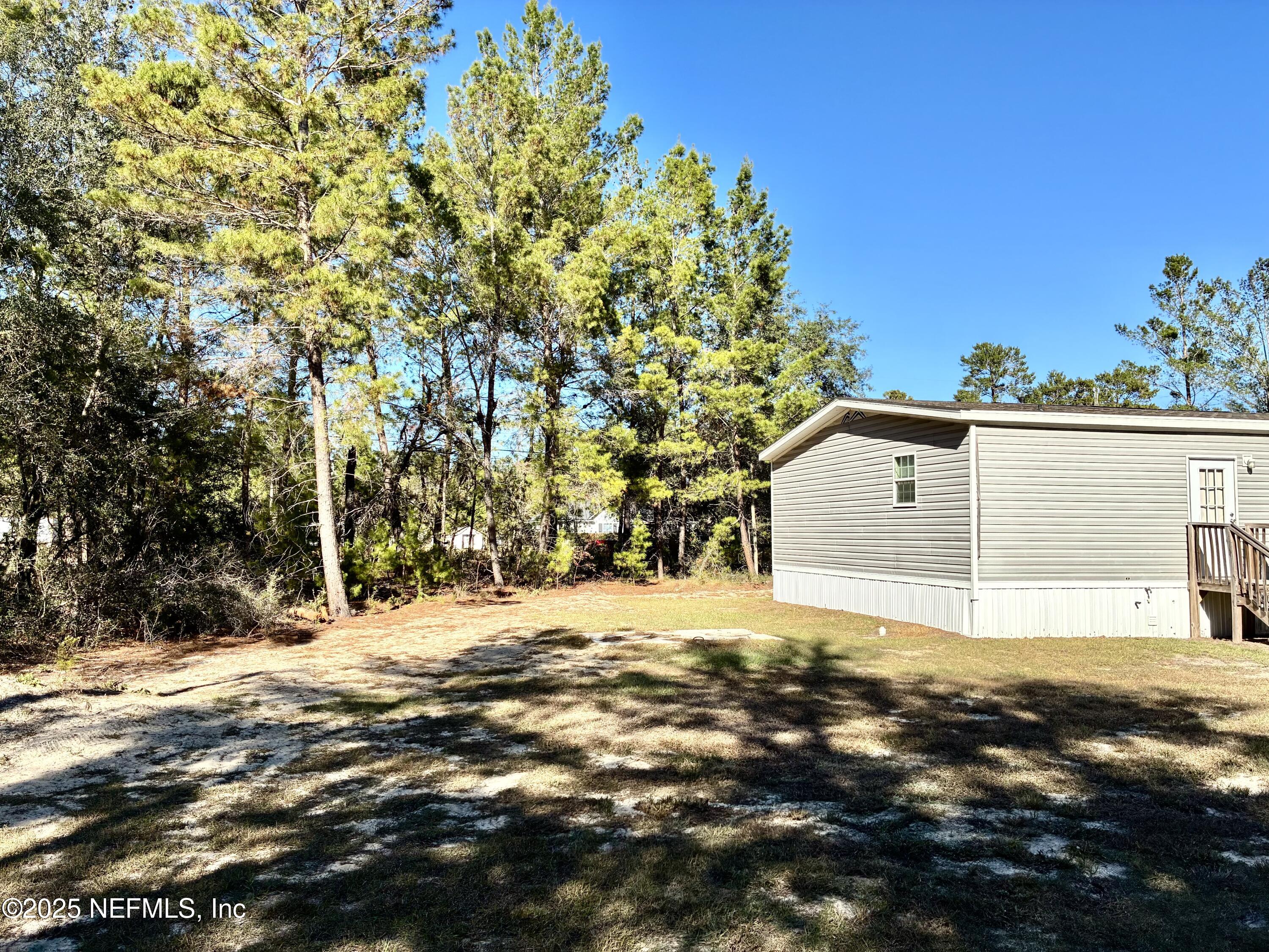 5915 Oak Leaf Road Keystone Heights, FL 32656 - Photo 4 of 44 a front view of a house with a yard and garage