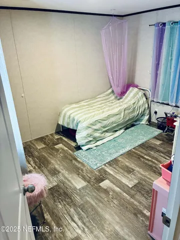 a bedroom with a bed and a mirror