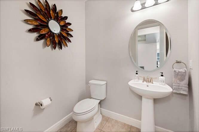 6564 Bay Ridge Way Fort Myers, FL 33908 - Photo 13 of 17 a bathroom with a toilet sink and mirror