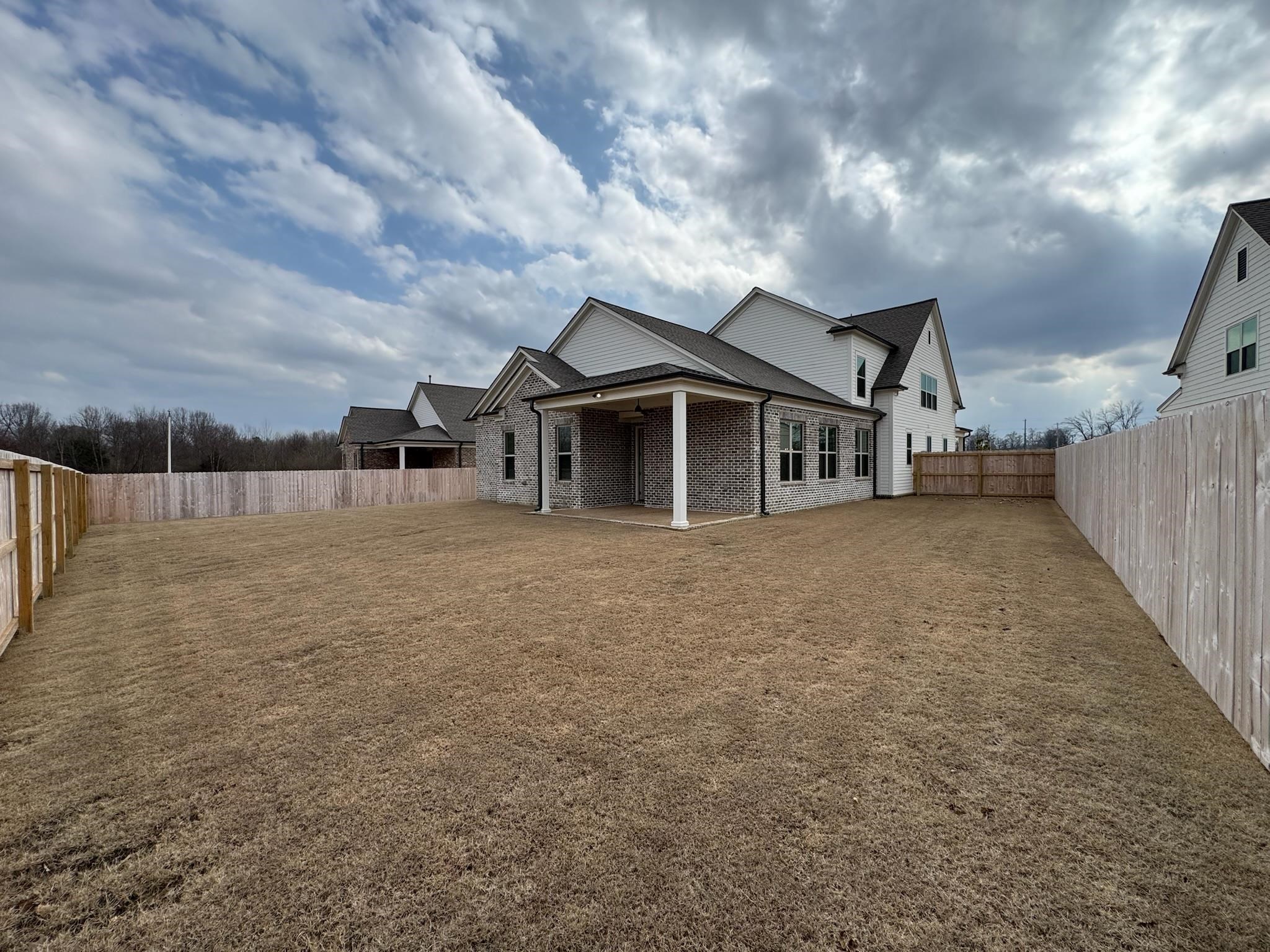 11512 Sunsparkler Way Collierville, TN 38017 - Photo 12 of 40 Back of house featuring a patio area, a fenced backyard, and brick siding