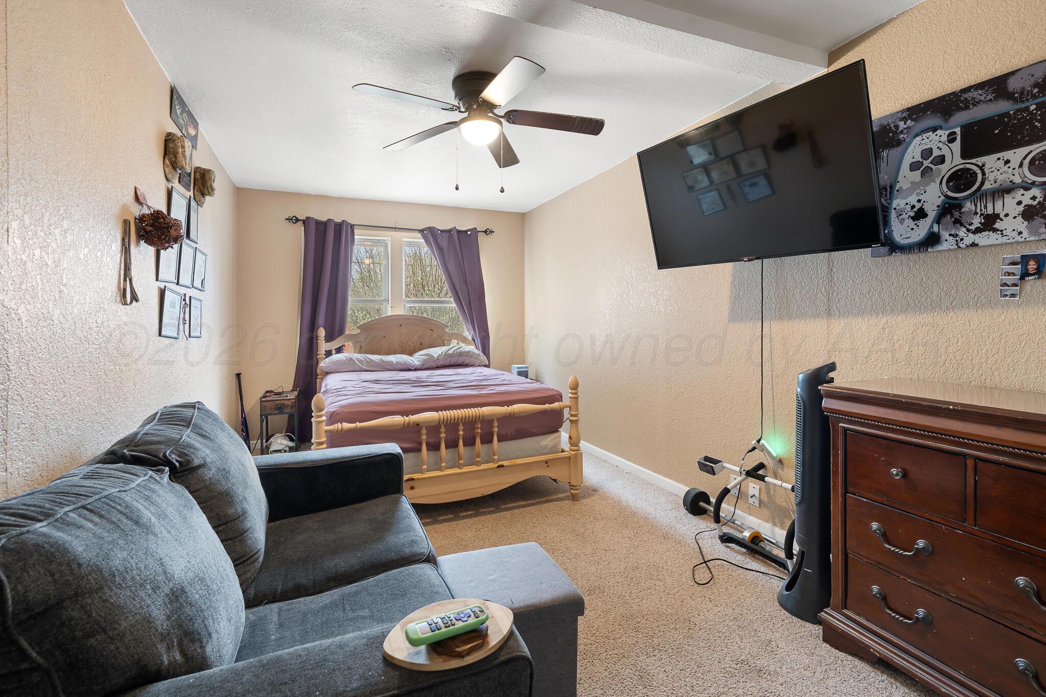 4603 Parker Street Amarillo, TX 79110 - Photo 12 of 20 a bedroom with furniture and a window