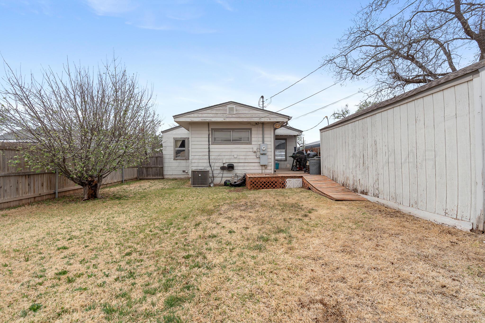 4603 Parker Street Amarillo, TX 79110 - Photo 20 of 20 a white house that has a tree in front of it