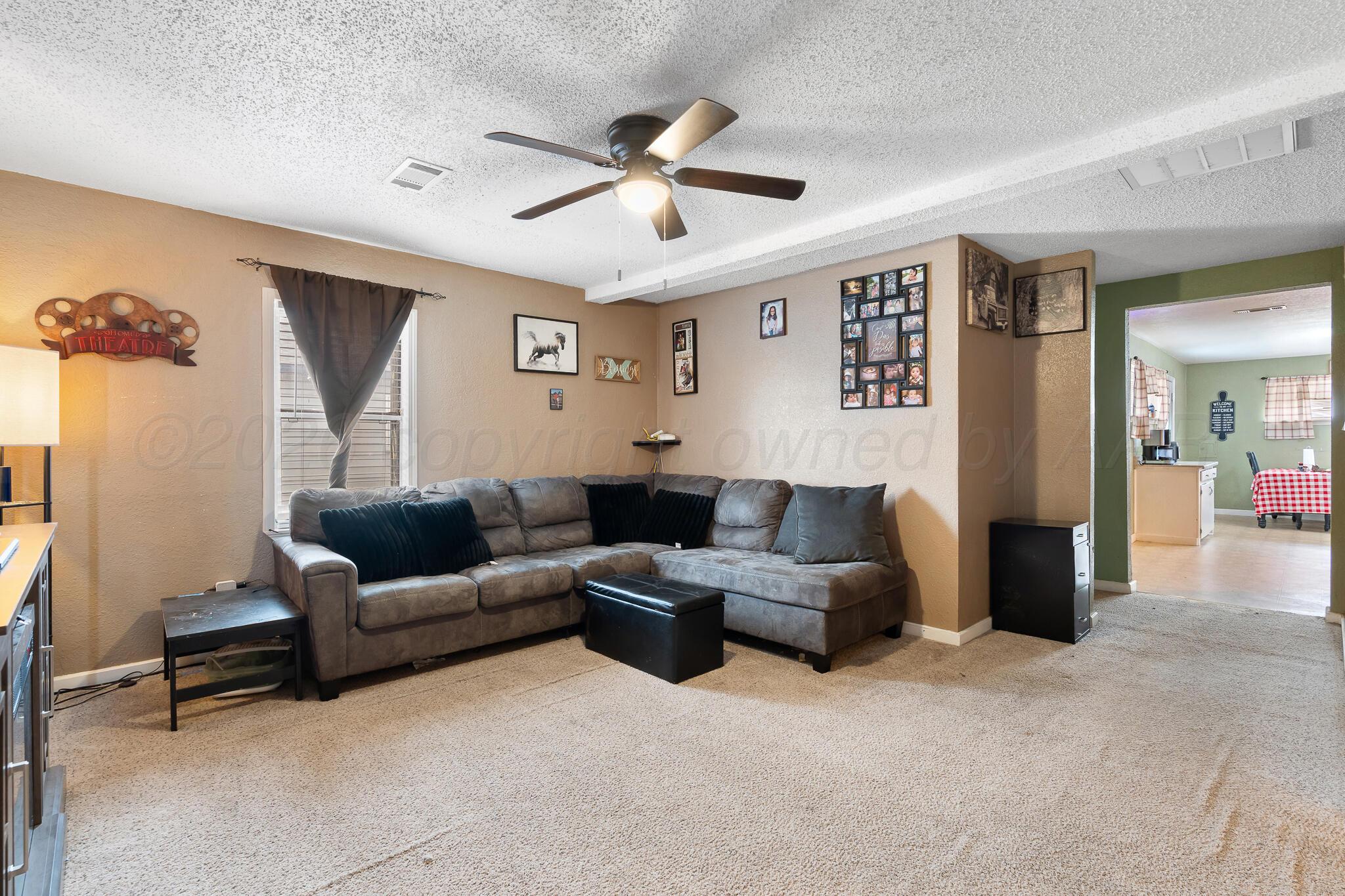 4603 Parker Street Amarillo, TX 79110 - Photo 5 of 20 a living room with furniture and a ceiling fan