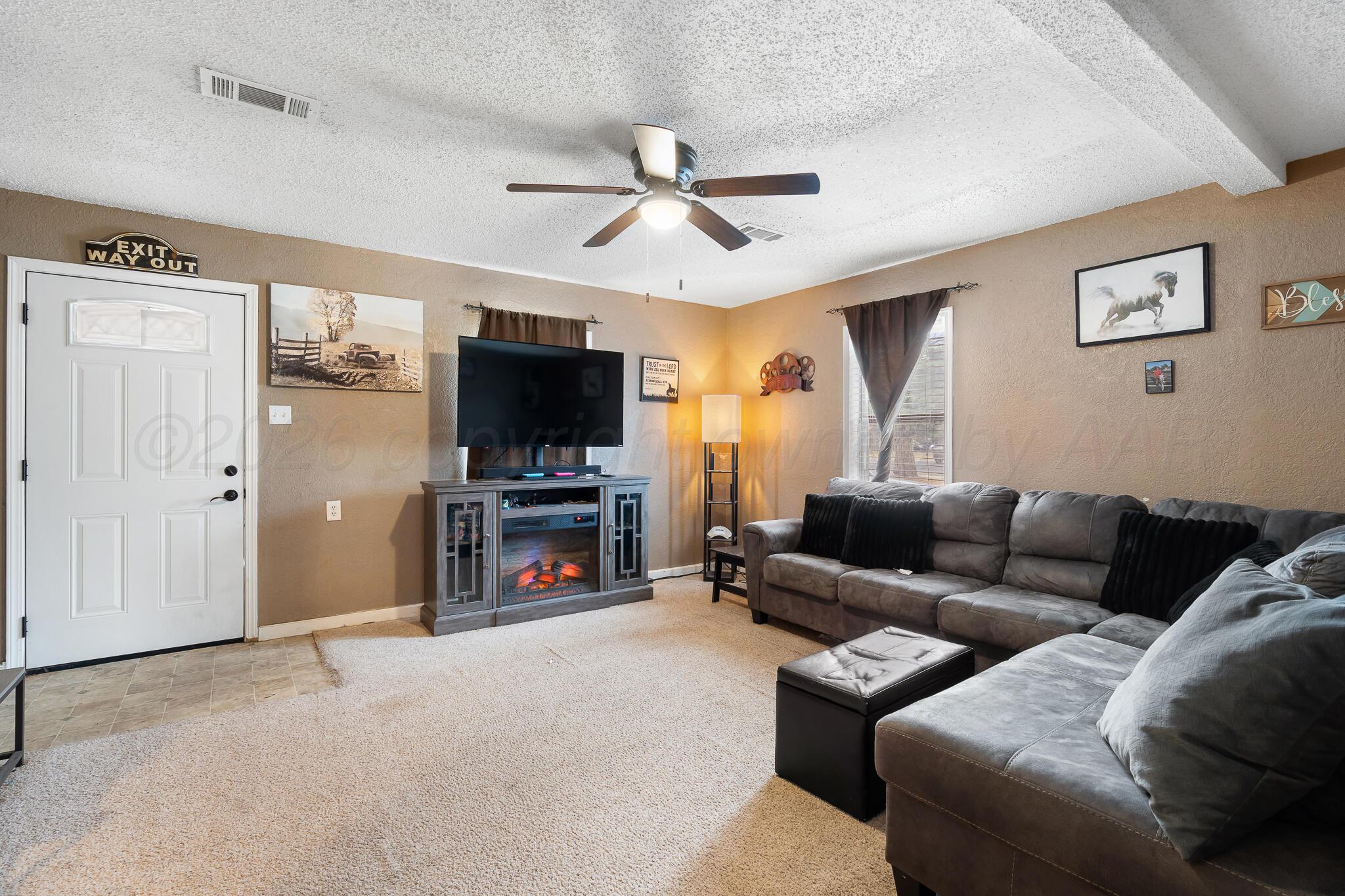 4603 Parker Street Amarillo, TX 79110 - Photo 6 of 20 a living room with furniture and a flat screen tv