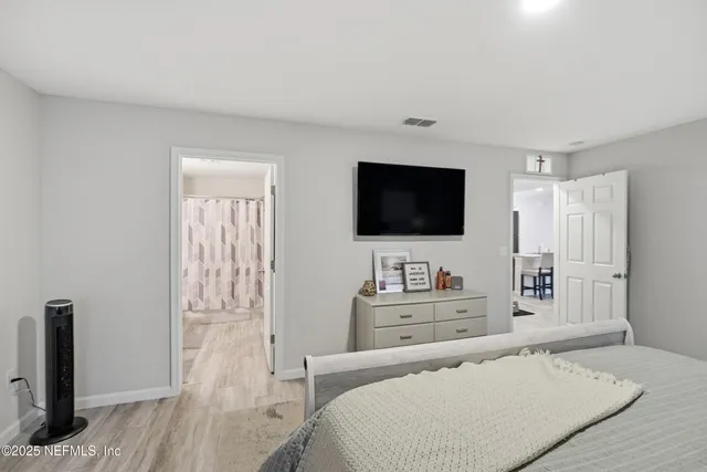 a bedroom with a bed and a flat screen tv