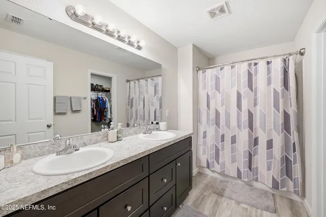 a bathroom with a double vanity sink mirror and double