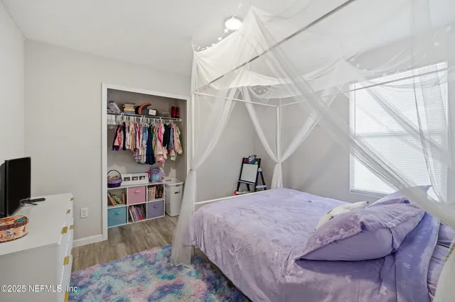 a bedroom with a bed and a flat screen tv