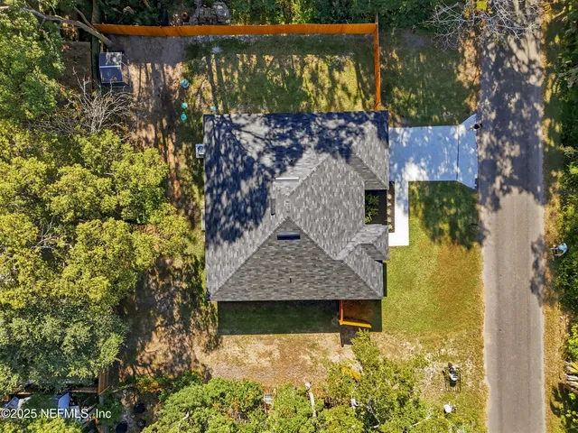 an aerial view of a house with a yard basket ball court and outdoor seating