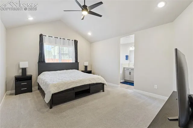 a bedroom with a bed and a flat tv screen on dresser